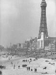 Girl Playing in the Sand while an Older Woman Gets Her Feet Wet in the Ocean at Blackpool Beach-Ian Smith-Photographic Print