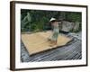 Iban Tribeswoman Raking Through Drying Rice Crop on Sacking Laid on Bamboo Longhouse Verandah-Annie Owen-Framed Photographic Print