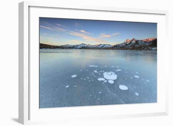 Ice Bubbles on the Frozen Surface of Andossi Lake at Sunrise, Spluga Valley, Valtellina, Italy-Roberto Moiola-Framed Photographic Print