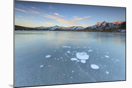 Ice Bubbles on the Frozen Surface of Andossi Lake at Sunrise, Spluga Valley, Valtellina, Italy-Roberto Moiola-Mounted Photographic Print