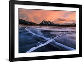 Ice cracks along Abraham Lake in Banff, Canada at sunset with pink clouds and scenic mountains-David Chang-Framed Photographic Print