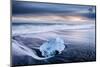 Ice on black volcanic sand with waves, Jokulsarlon, Iceland-Ross Hoddinott-Mounted Photographic Print