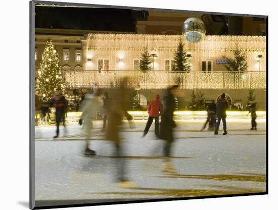 Ice Skating at Night on Ice Rink at Mozartplatz Square, Salzburg, Austria, Europe-Richard Nebesky-Mounted Photographic Print