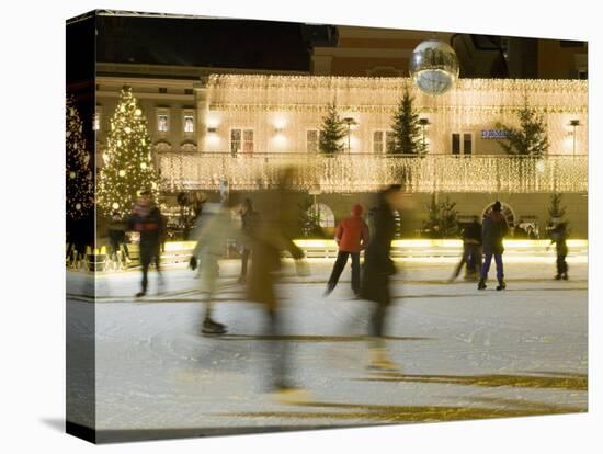 Ice Skating at Night on Ice Rink at Mozartplatz Square, Salzburg, Austria, Europe-Richard Nebesky-Stretched Canvas