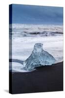 Iceberg from melting glacier on black sand beach near Jokulsarlon glacier lagoon-Ed Hasler-Stretched Canvas