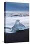 Iceberg from melting glacier on black sand beach near Jokulsarlon glacier lagoon-Ed Hasler-Stretched Canvas