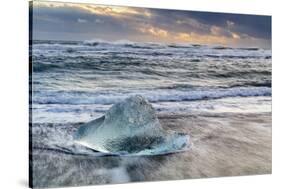 Iceberg from melting glacier on black sand beach near Jokulsarlon glacier lagoon-Ed Hasler-Stretched Canvas