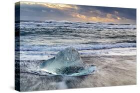 Iceberg from melting glacier on black sand beach near Jokulsarlon glacier lagoon-Ed Hasler-Stretched Canvas