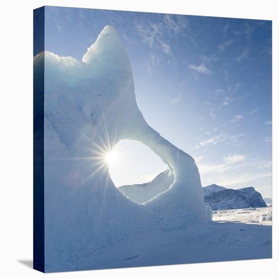 Iceberg frozen into the sea ice of the Uummannaq fjord system during winter. Greenland-Martin Zwick-Stretched Canvas