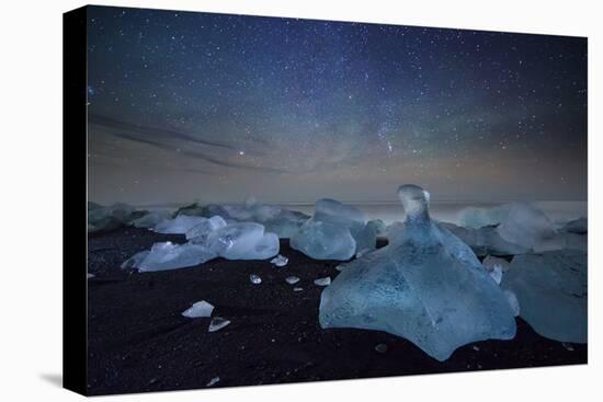 Iceberg on Black Sand Beach with Dramatic Sky-Alex Saberi-Stretched Canvas