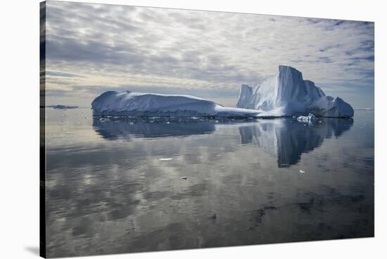 Iceberg reflected in still water of the Crystal Sound, Antarctic Peninsula, Antarctica-Michel Roggo-Stretched Canvas