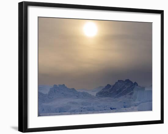 Icebergs frozen into the sea ice of the Uummannaq fjord system during winter. Greenland-Martin Zwick-Framed Photographic Print