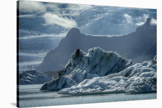 Iceland, floating glaciers in Jokulsarlon, glacier lagoon with mountain echo.-Mark Williford-Stretched Canvas