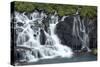 Iceland, Hraunfossar. Tiny cascades emerge from the lava to flow into the Hvita River-Ellen Goff-Stretched Canvas