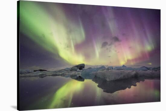 Iceland, Jokulsarlon. Aurora lights reflect in lagoon.-Josh Anon-Stretched Canvas