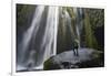 Iceland, Seljalandsfoss. Woman on large rock in front of streaming falls in green slot canyon. (MR)-Mark Williford-Framed Photographic Print