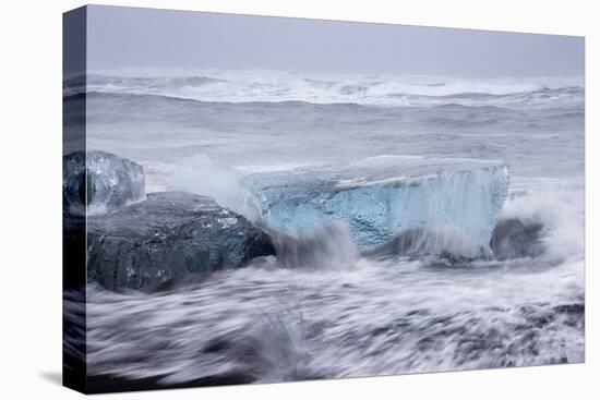 Iceland, Skaftafell National Park, Surf hits glacial ice on a black sand beach.-Ellen Goff-Stretched Canvas