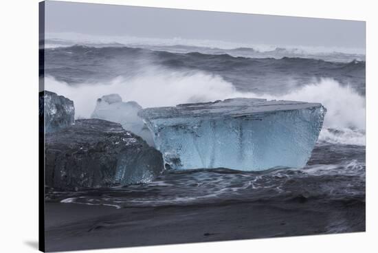 Iceland, Skaftafell National Park, Surf hits glacial ice on a black sand beach.-Ellen Goff-Stretched Canvas