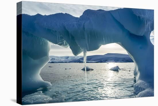 Icicles hang from an iceberg floating by Enterprise Island, Antarctica-Paul Souders-Stretched Canvas