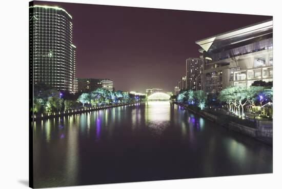 Illuminated architecture and reflections at night in Hangzhou City Center, Hangzhou, Zhejiang, Chin-Andreas Brandl-Stretched Canvas