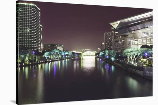 Illuminated architecture and reflections at night in Hangzhou City Center, Hangzhou, Zhejiang, Chin-Andreas Brandl-Stretched Canvas