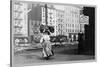 Immigrant Woman Walks Down Street Carrying a Pile of Clothing on Her Head-null-Stretched Canvas