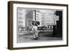 Immigrant Woman Walks Down Street Carrying a Pile of Clothing on Her Head-null-Framed Art Print