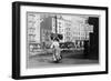 Immigrant Woman Walks Down Street Carrying a Pile of Clothing on Her Head-null-Framed Art Print