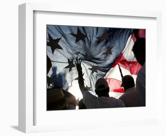 Immigration Rights Demonstrators Hold a U.S. Flag Aloft During a March Along Wilshire Boulevard-null-Framed Photographic Print