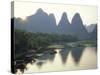 In Guilin Limestone Tower Hills Rise Steeply Above the Li River, Yangshuo, Guangxi Province, China-Anthony Waltham-Stretched Canvas