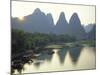 In Guilin Limestone Tower Hills Rise Steeply Above the Li River, Yangshuo, Guangxi Province, China-Anthony Waltham-Mounted Photographic Print