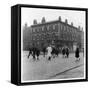 In Liverpool, a Lollipop Lady Helps Children Cross a Cobbled Street-Henry Grant-Framed Stretched Canvas