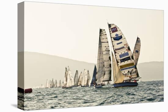 In the start of the yachting regatta Centomiglia in 2012 in front of the harbour of Bogliaco, Lake -Rasmus Kaessmann-Stretched Canvas