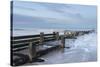 Incoming waves hitting a groyne at Walcott, Norfolk, England, United Kingdom, Europe-Jon Gibbs-Stretched Canvas