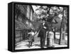 Incredibly Well Dressed Man, Woman and Child Walking by Perfect Brownstone Apartment Buildings-George B^ Brainerd-Framed Stretched Canvas