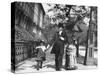 Incredibly Well Dressed Man, Woman and Child Walking by Perfect Brownstone Apartment Buildings-George B^ Brainerd-Stretched Canvas