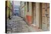 India, Varanasi a Man Walking Down a Stone Tiled Street in the Downtown Area-Ellen Clark-Stretched Canvas