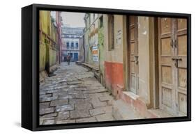 India, Varanasi a Man Walking Down a Stone Tiled Street in the Downtown Area-Ellen Clark-Framed Stretched Canvas