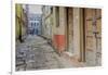 India, Varanasi a Man Walking Down a Stone Tiled Street in the Downtown Area-Ellen Clark-Framed Photographic Print