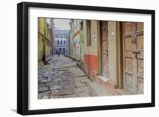 India, Varanasi a Man Walking Down a Stone Tiled Street in the Downtown Area-Ellen Clark-Framed Photographic Print