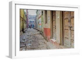 India, Varanasi a Man Walking Down a Stone Tiled Street in the Downtown Area-Ellen Clark-Framed Photographic Print