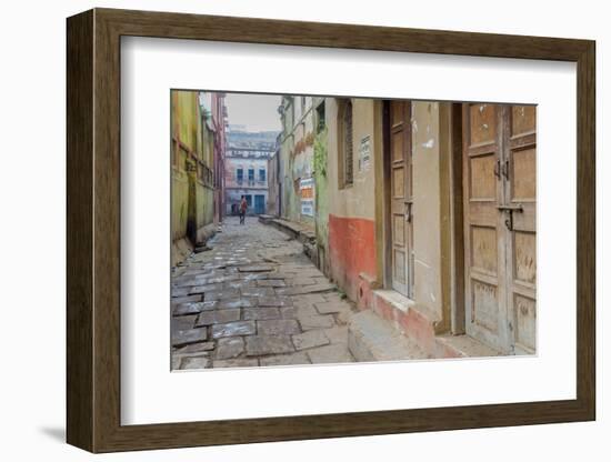 India, Varanasi a Man Walking Down a Stone Tiled Street in the Downtown Area-Ellen Clark-Framed Photographic Print