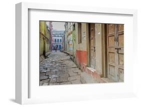 India, Varanasi a Man Walking Down a Stone Tiled Street in the Downtown Area-Ellen Clark-Framed Photographic Print