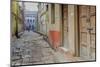 India, Varanasi a Man Walking Down a Stone Tiled Street in the Downtown Area-Ellen Clark-Mounted Photographic Print