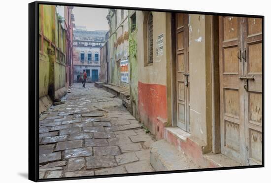 India, Varanasi a Man Walking Down a Stone Tiled Street in the Downtown Area-Ellen Clark-Framed Stretched Canvas