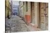 India, Varanasi a Man Walking Down a Stone Tiled Street in the Downtown Area-Ellen Clark-Stretched Canvas