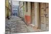 India, Varanasi a Man Walking Down a Stone Tiled Street in the Downtown Area-Ellen Clark-Mounted Photographic Print