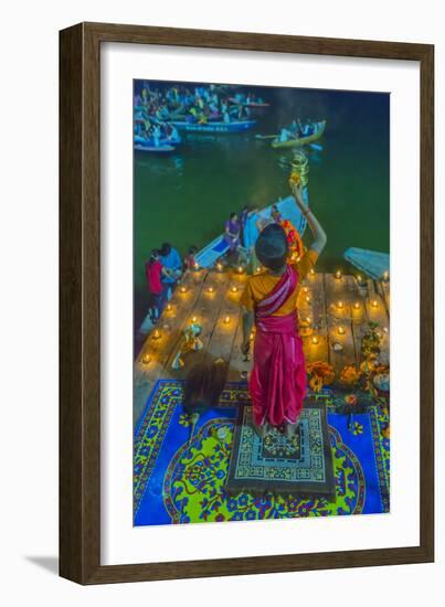 India, Varanasi Young Boy in Pink and Yellow Robes Holds Up an Offering to the Ganges River-Ellen Clark-Framed Photographic Print