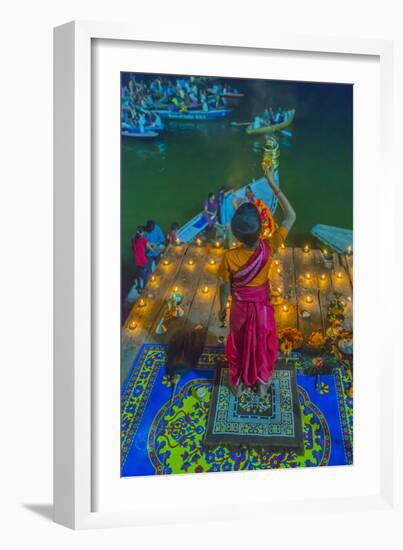 India, Varanasi Young Boy in Pink and Yellow Robes Holds Up an Offering to the Ganges River-Ellen Clark-Framed Photographic Print