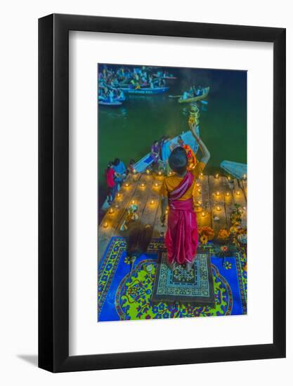 India, Varanasi Young Boy in Pink and Yellow Robes Holds Up an Offering to the Ganges River-Ellen Clark-Framed Photographic Print